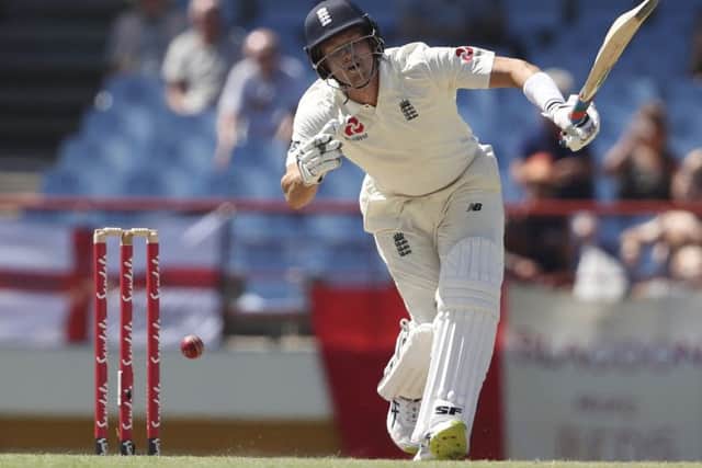 Englands Joe Denly struggles to play a delivery from the West Indies bowler Kemar Roach yesterday (Picture: Ricardo mazalan/AP).