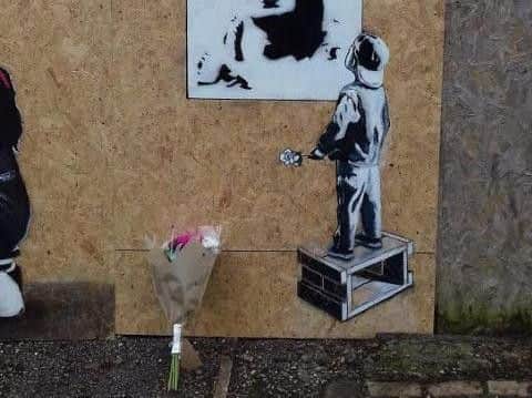 Someone has already left flowers at the new artwork