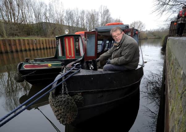 Float Your Boat's Alan Bolton with his dog Jasper. Picture by Simon Hulme