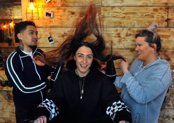 Aimee Stewart (centre) at Blak Bear barbering in York with barbers Bryan David and Manager Rosie Williamson.