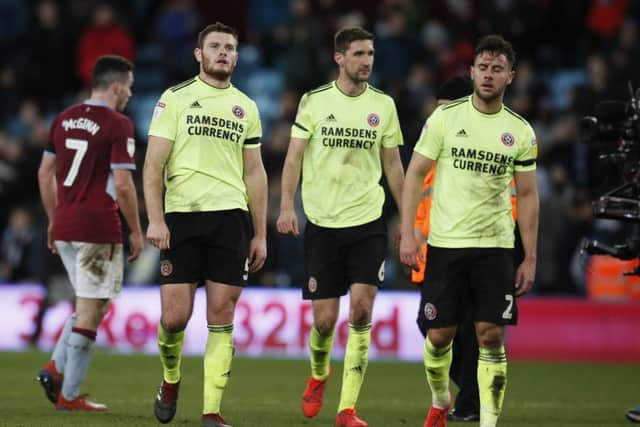 Jack O'Connell, Chris Basham and George Baldock leave the field frustrated at Villa Park. Picture: Simon Bellis/Sportimage