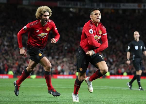 Manchester United's Alexis Sanchez (right) celebrates scoring his side's third goal of the game with Marouane Fellaini during the Premier League match at Old Trafford, Manchester. PRESS ASSOCIATION Photo. Picture date: Saturday October 6, 2018. See PA story SOCCER Man Utd. Photo credit should read: Martin Rickett/PA Wire. RESTRICTIONS: EDITORIAL USE ONLY No use with unauthorised audio, video, data, fixture lists, club/league logos or "live" services. Online in-match use limited to 120 images, no video emulation. No use in betting, games or single club/league/player publications.