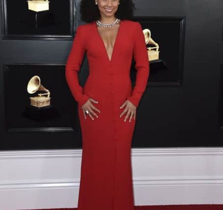 Choose bold red but keep it classy: Alicia Keys hosts the Grammy Awards in slinky red (Photo by Jordan Strauss/Invision/AP)