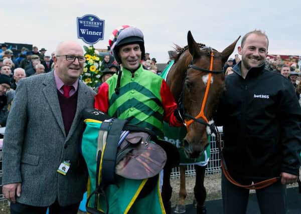 Owner Phil Martin, left, with jockey Danny Cook after Definitly Red's Charlie Hall Chase win (Picture: Richard Sellers/PA Wire).