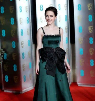 HUGE BOWS: American actress Rachel Brosnahan, who won Best Actress TV Series Musical or Comedy for The Marvelous Mrs. Maisel at the Golden Globes 2019, wears a forest green satin Erden gown that's dominated by a huge black glistening bow. Both the bow size and positioning are excellent news for all those of us who prefer to eat our dinner rather than pick at it. Picture: Jonathan Brady/PA Wire