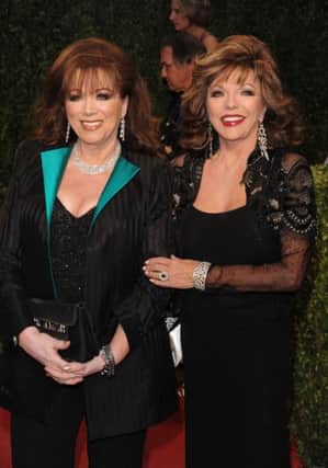 FILE - In this Feb. 22, 2009 file photo, actress Joan Collins, right, poses with her sister, author Jackie Collins at the Vanity Fair Oscar party in West Hollywood, Calif. Jackie Collins, died in Los Angeles on Saturday, Sept. 19, 2015, of breast cancer. She was 77. (AP Photo/Evan Agostini, File)
