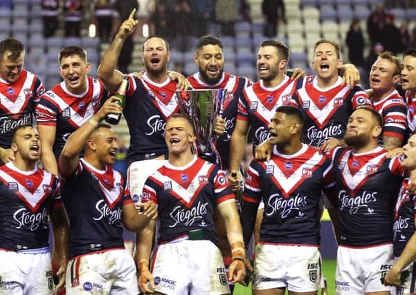 Sydney Roosters' Boyd Cordner (centre left) and team-mates celebrate with the trophy after winning the World Club Challenge.