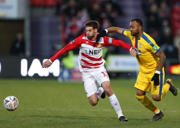 Doncaster Rovers Matty Blair with Jordan Ayew of Crystal Palace during Sundays FA Cup fifth-round tie at the Keepmoat Stadium (Picture: James Wilson/Sportimage).