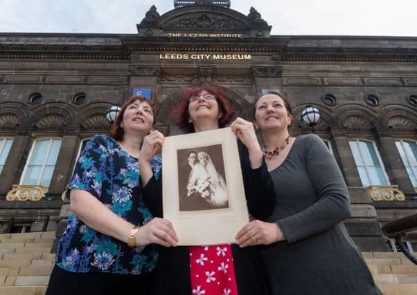 Harriet Stevens, Jess Rusell, and Rachel Stevens, daughters of Eric, holding a picture of the grandparents on thier Wedding Day in Vienna in 1920.