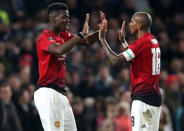 Going through: Manchester United's Paul Pogba celebrates scoring his side's second goal against Chelsea with Ashley Young.