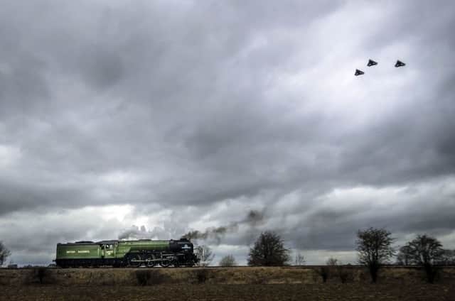 Three RAF Tornados fly past the Tornado train near Leeming Bar in Yorkshire during their farewell tour.