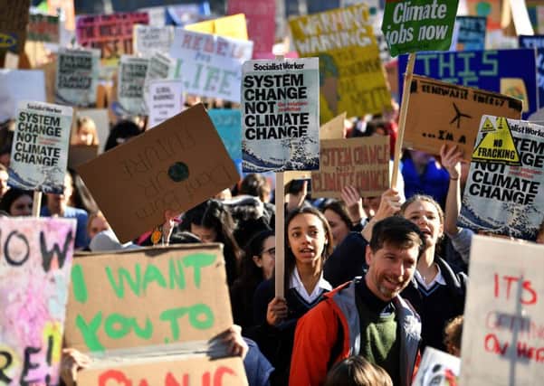Young demonstrators hold placards as they attend a climate change protest opposite the Houses of Parliament last week. Picture: Ben Stansall/AFP/Getty Images.