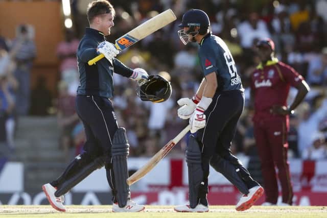 Englands Jason Roy, left, celebrates his century with Joe Root who would go on to get a ton of his own in Bridgetown as they beat the West Indies (Picture: Ricardo Mazalan/AP).