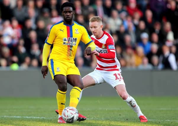 Ready for derby: Doncaster's Ali Crawford, right, challenging Crystal Palace's Jeffrey Schlupp in the FA Cup encounter.