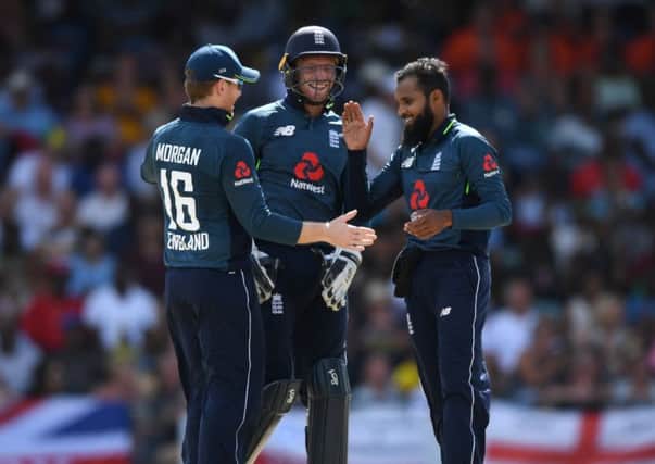 KEY MAN: Adil Rashid celebrates with Eoin Morgan and Jos Buttler after dismissing West Indies captain Jason Holder during the 1st One Day International match on Wednesday Picture: Gareth Copley/Getty Images