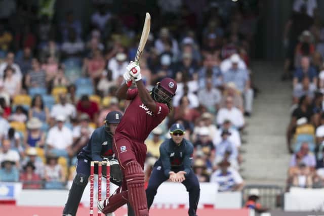 West Indies' Chris Gayle hits a six off the bowling of England's Moeen Ali at the Kensington Oval in Bridgetown. Picture: AP/Ricardo Mazalan