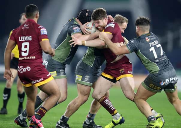 Huddersfield Giants' Adam Walne is tackled during the Betfred Super League match at the John Smith's Stadium, Huddersfield (Picture: PA)