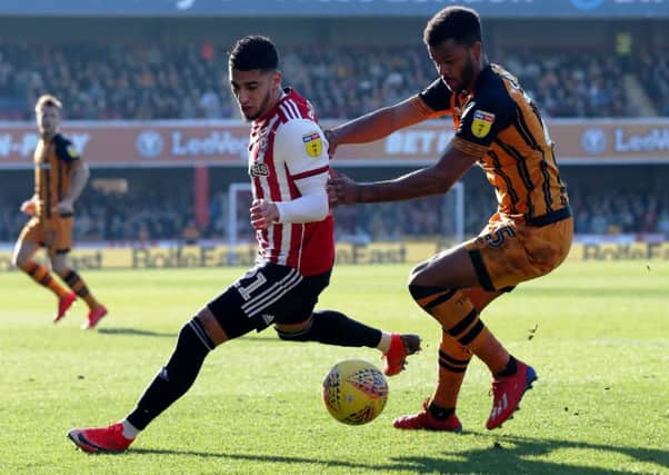 Brentford's Said Benrahma (left) gets past Hull City's Fraizer Campbell (right).