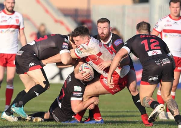 NO WAY THROUGH: Hull KR's Robbie Mulhern is stopped by a clutch of Salford Red Devils players. Picture: Ash Allen/SWpix.com