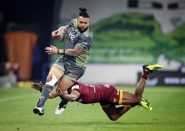 Warrington Wolves' Ben Murdoch-Masila (left) makes a break past Huddersfield Giants' Akuila Uate at the John Smith's Stadium. Picture: Danny Lawson/PA.