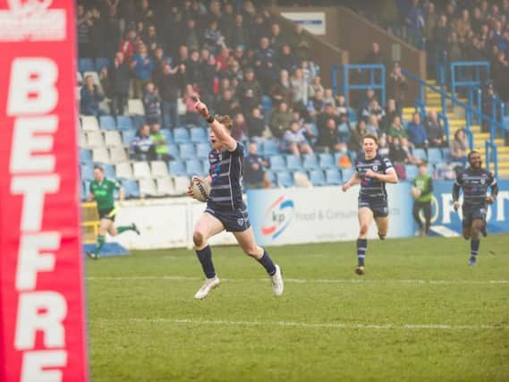 Harry Newman points to the Featherstone fans on his way to the tryline. PIC: James Heaton.