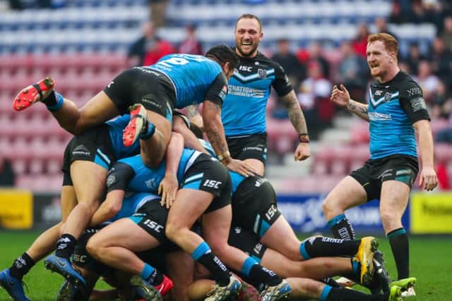 Delighted Hull FC players celebrate winning in extra time after a drop goal by Marc Sneyd.