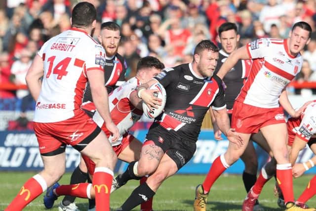 Hull KR captain Joel Tomkins, pictured far right, in action against Salford Red Devils on Saturday. He has been charged for an alleged offence during this game. (SWPix)