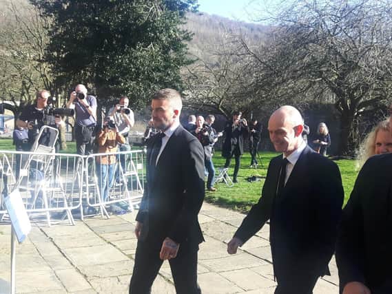 David Beckham and Gary Neville arrive at the funeral of Eric Harrison.