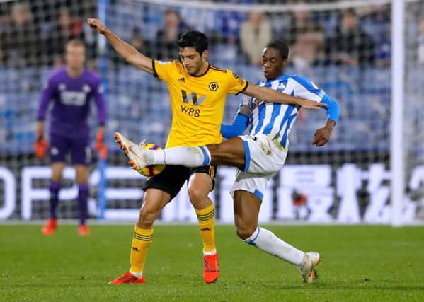 Huddersfield Towns Terence Kongolo, right, challenges Wolverhampton Wanderers' Raul Jimenez on Tuesday night (Picture: Martin Rickett/PA Wire).