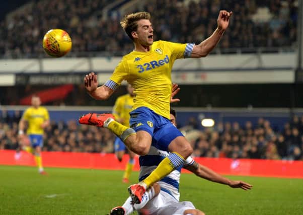 Tangled up: Leeds United striker Patrick Bamford is caught by Queens Park Rangers defender Grant Hall during last nights defeat for the Championship promotion hopefuls. (Picture: Bruce Rollinson)