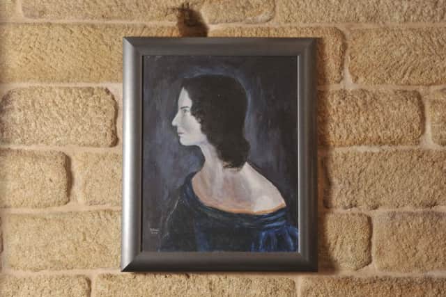 A portrait of Emily Bronte in Ponden Hall.