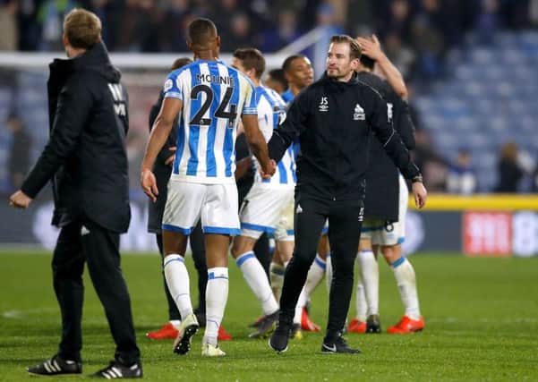 Huddersfield Town manager Jan Siewert (right) shakes hands with Steve Mounie.