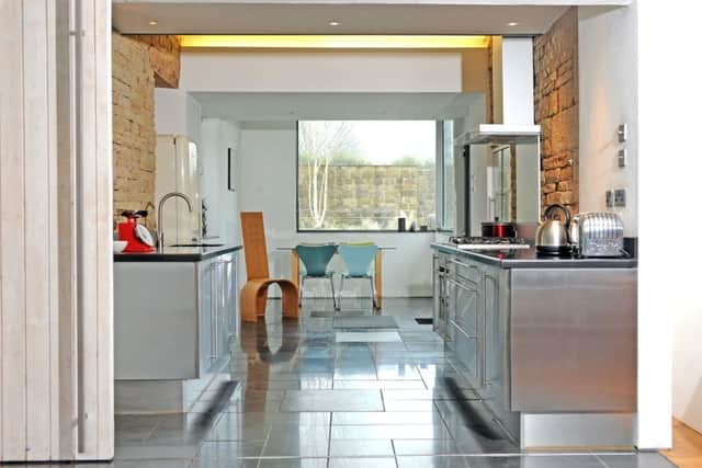 The kitchen with an extension that provides a dining space. The bentwood chair was made by Julie