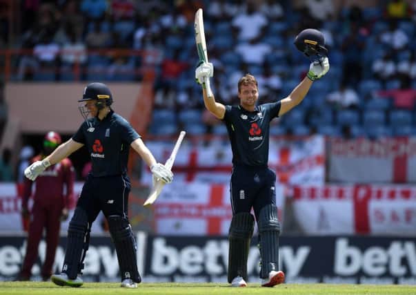 Jos Buttler of England celebrates reaching his century with captain Eoin Morgan.    (Photo by Gareth Copley/Getty Images)