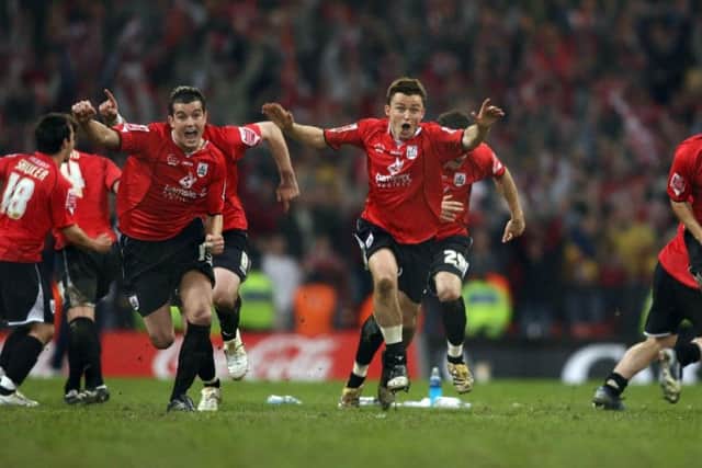 Barnsley players, including Dale Tonge and Paul Heckingbottom celebrate as goalkeeper Nick Colgon saves a penalty kick from Swansea's Alan Tate during the Coca Cola League One play-off final at the Millennium Stadium in May 2006. Picture: Chris Young/PA