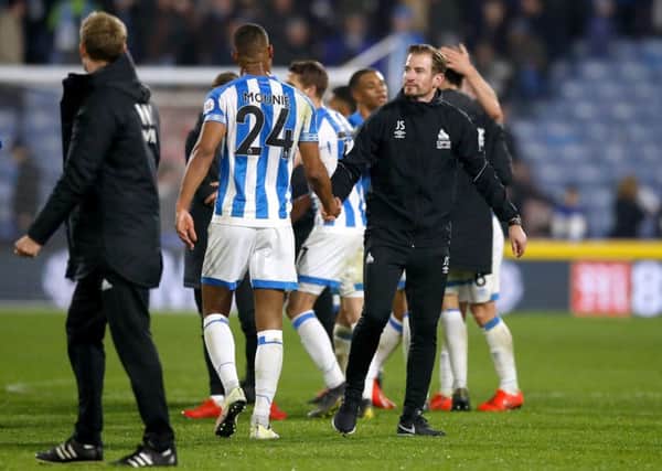 well done: Huddersfield Town head coach Jan Siewert shakes hands with match-winner Steve Mounie on Tuesday (Picture: Martin Rickett/PA Wire).