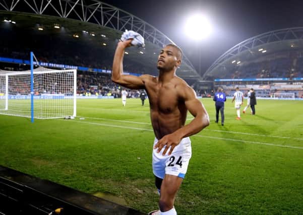 Match-winner: Huddersfield Town's Steve Mounie throws his shirt to fans after neeting against Wolves.