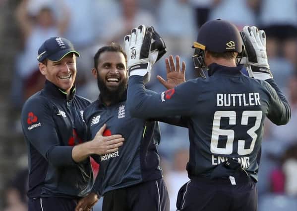 England's spin bowler Adil Rashid celebrates with captain Eoin Morgan and wicket keeper Jos Buttler after dismissing West Indies' Oshane Thomas at the National Stadium in St. George's . Picture: AP/Ricardo Mazalan