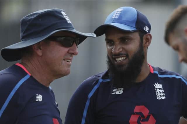 England's cricket team head coach Trevor Bayliss left, talks to spin bowler Adil Rashid. Picture: AP Photo/Ricardo Mazalan