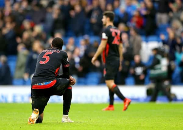 Huddersfield Town's Terence Kongolo appears dejected after the final whistle.