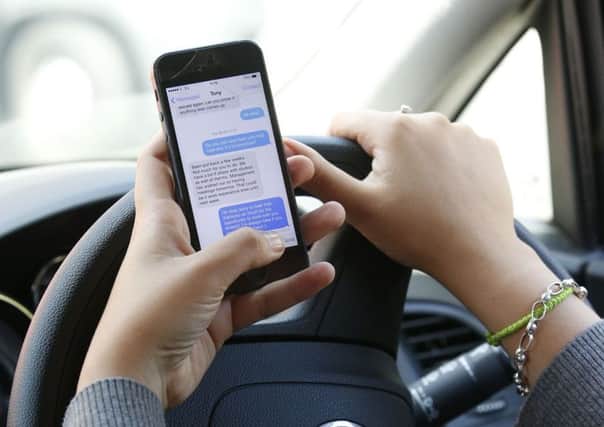 A cut in the number of traffic police officers has led to a significant drop in people being prosecuted for driving while using a mobile phone, the RAC said. Picture: Jonathan Brady/PA Wire.
