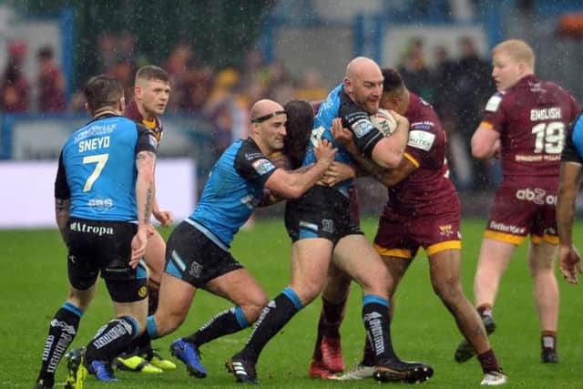 Hull FC's Gareth Ellis - playing his second game back from retirement - takes it into Huddersfield (PIC: Tony Johnson)