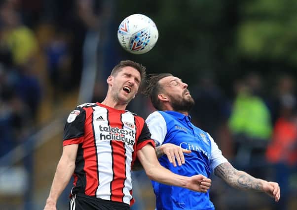 Sheffield United's Chris Basham and Sheffield Wednesday's Steven Fletcher battle during the most recent Steel City derby clash at Hillsborough, which the Blades won 4-2. Picture: Mike Egerton/PA.