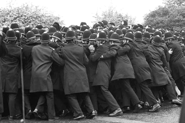 File photo dated 01/06/1984 of police officers pushing against striking miners outside the Orgreave Coking Plant near Rotherham.
