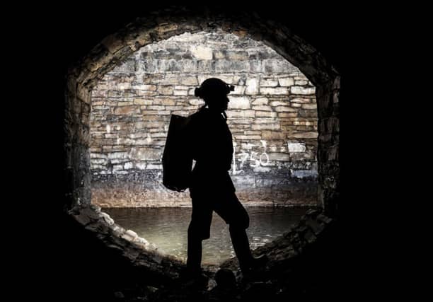 A man urban caving as an underground network of rivers are opened up to the public for an audio-visual spectacular during the Sheffield Adventure Film Festival. Picture: Danny Lawson/PA