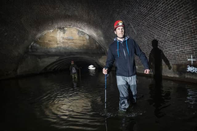 A man urban caving as an underground network of rivers are opened up to the public for an audio-visual spectacular during the Sheffield Adventure Film Festival. Picture: Danny Lawson/PA