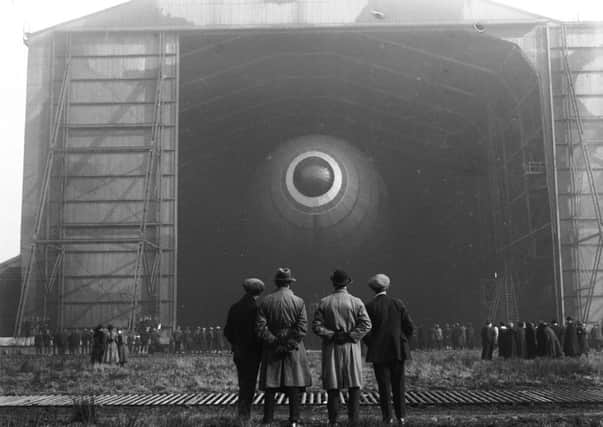 Then: The British airship R33 in its hangar as it prepares for its first ever flight at an aerodrome in Barlow, North Yorkshire.  Pic: R. Humphrey/Topical Press Agency/Getty Images.