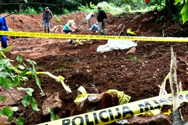 Forensics teams work at the site of a mass grave in Bosnia (Picture: ELVIS BARUKCIC/AFP/Getty Images)