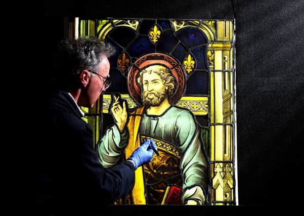 Stained glass expert Jonathan Cooke works on a piece from a church in Jersey. PIC: Tony Johnson