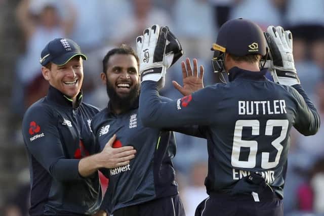 Spin king: England's Adil Rashid celebrates with captain Eoin Morgan and wicketkeeper Jos Buttler after dismissing West Indies' Oshane Thomas to win by 30 runs the fourth one-day international.